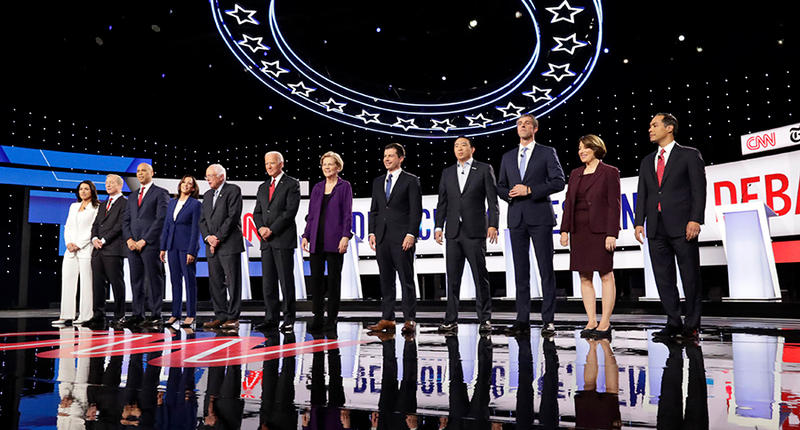 12 Democratic presidential candidates stand on stage before the October 15, 2019 debate in Westerville Ohio. 
