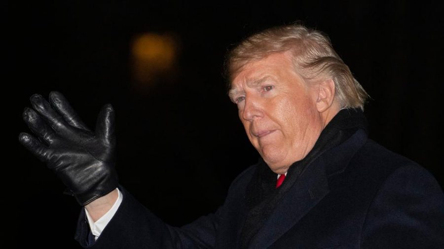 Trump waves to supporters  following his arrival in D.C. after his Christmas rally in Michigan. (Manuel Balce Ceneta / AP)