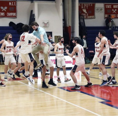  Mendham Boys' Basketball celebrates after a win during their 2020- 2021 winter season. Their winning season allowed for them to play in the summer showcase against the top team in NJ. Marty, number 5, is pictured in the middle.  "We only lost five games last year," Marty said