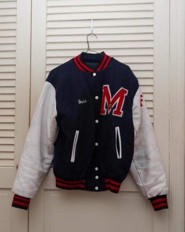 Photo by Audrey Gavagan. 21 January 2022. This photo shows the varsity jacket of a Mendham fencer. Letterman jackets are important mementos to many seniors that want to commemorate their time on their schools varsity team. When someone wears their varsity jacket, they are representing the Mendham athletic program.