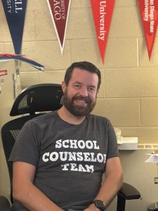 Mr. Sheerin sits smiling in his office, surrounded by his new decor