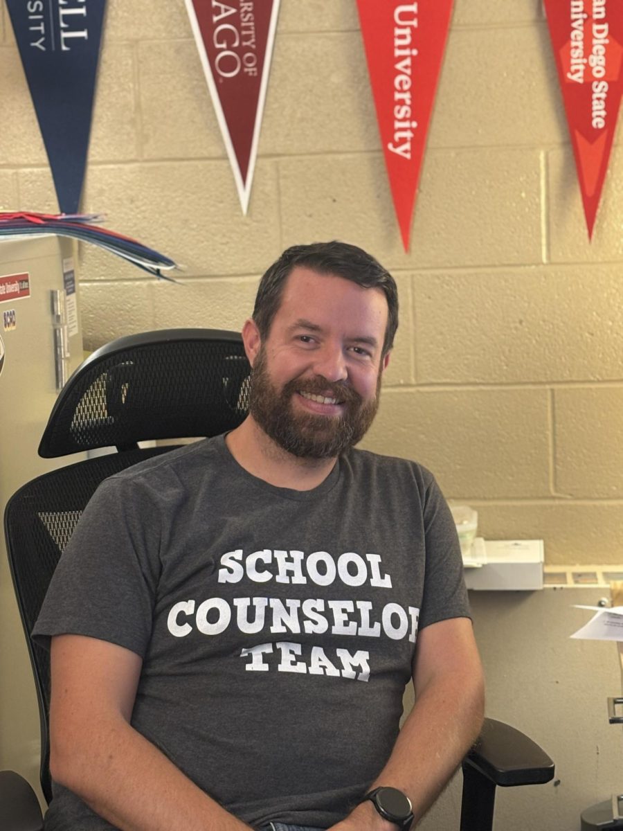 Mr. Sheerin sits smiling in his office, surrounded by his new decor